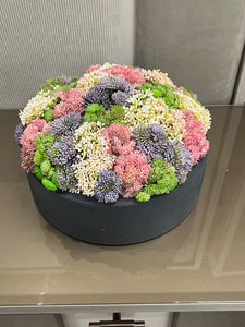 Black  Vase with  Flower Arrangement Colorful Greenery.