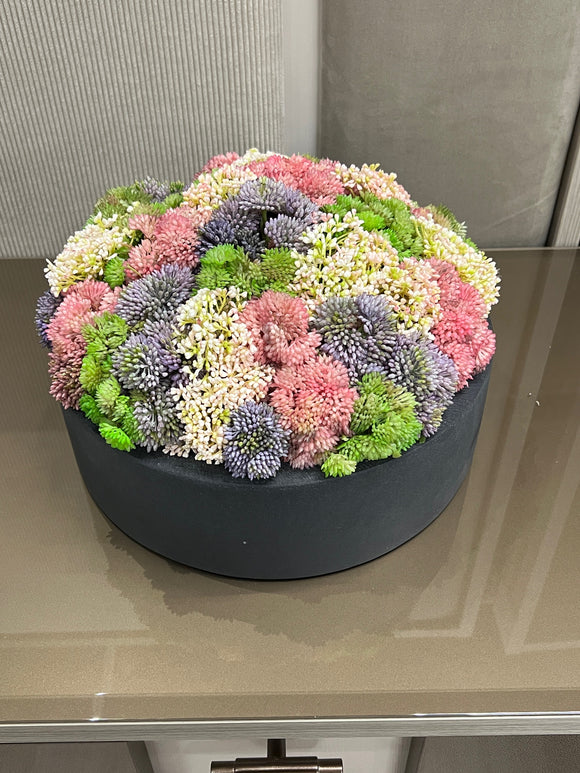 Black  Vase with  Flower Arrangement Colorful Greenery.
