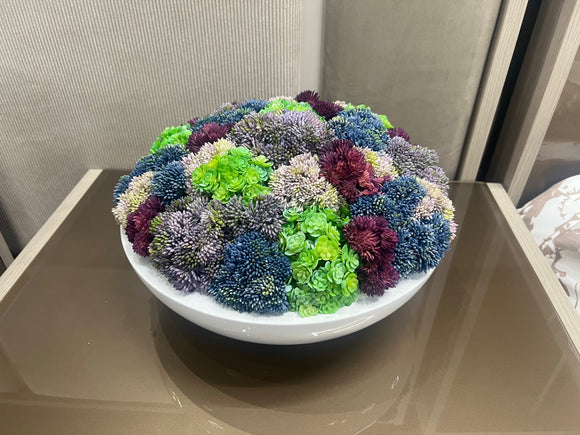 White Round Vase with Beautiful Multi Color Greenery.