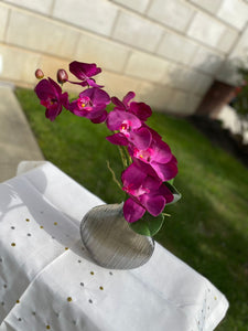 Small arrangement with purple orchids.