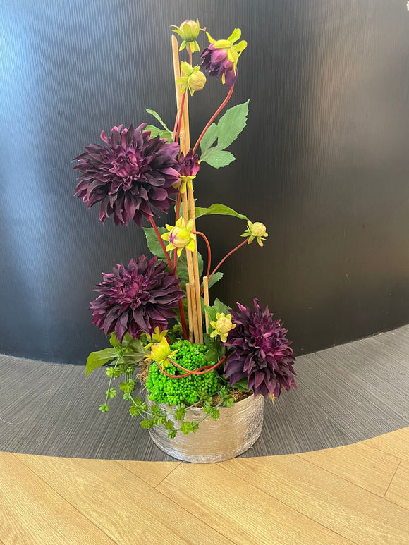 Purple flowers in silver vase