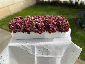 Burgundy boxwood arrangement