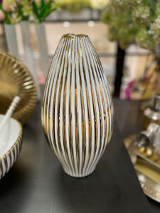 White and gold ceramic vase with stripes.
