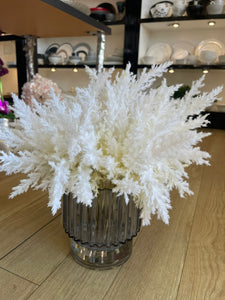 White arrangement in blue vase